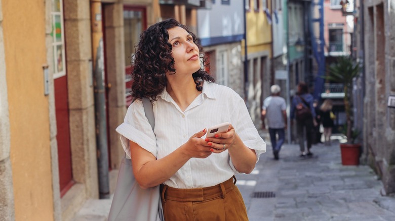 woman looking up from phone