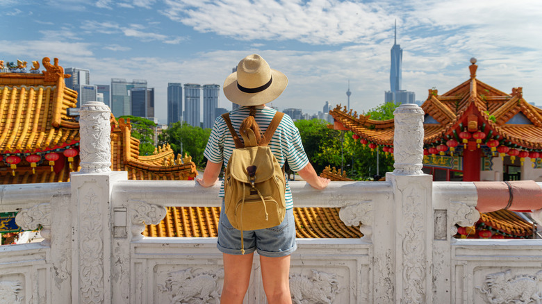 Female tourist overlooking city from a temple