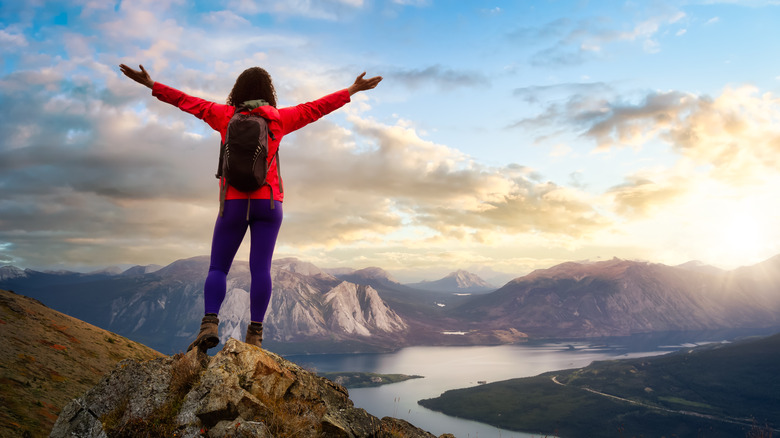 woman celebrating view from mountaintop