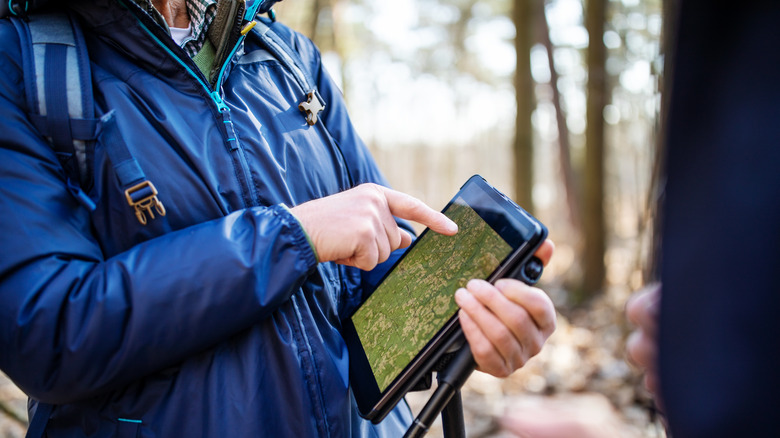 hiker with digital map
