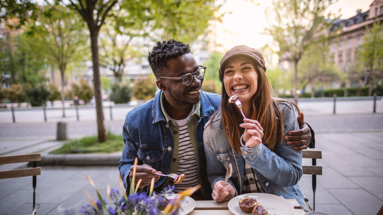 Two happy people eating