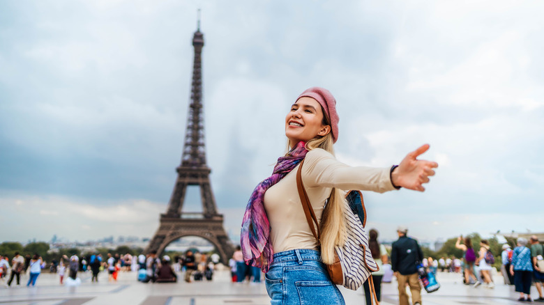 Traveler posing by the Eiffel Tower