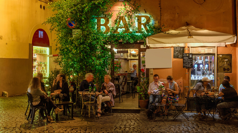 People at quiet Roman bar patio