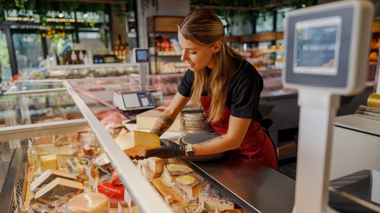 woman working at cheese counter in deli