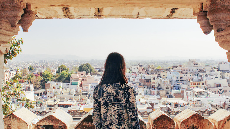 Traveler overlooking Udaipur city