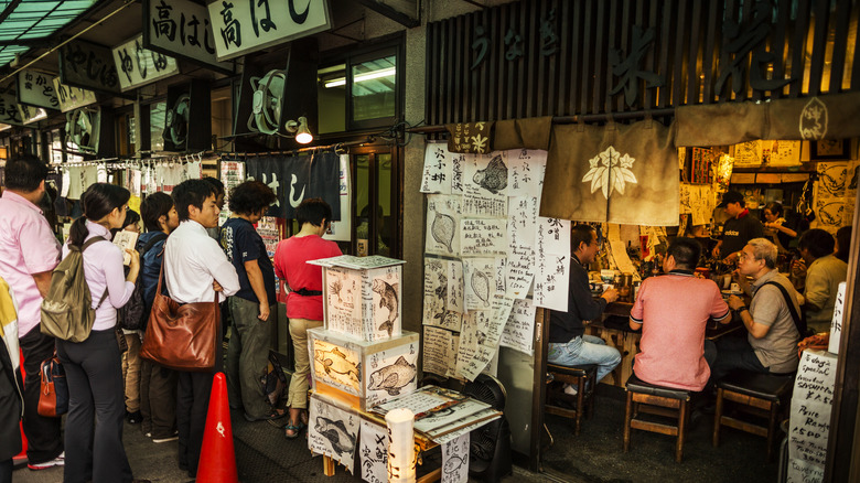 People waiting in line outside eatery in Tokyo