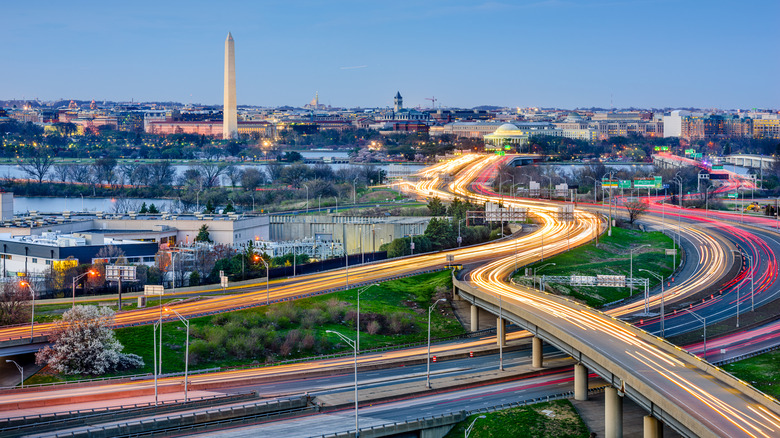 An aerial timelapse of traffic flashing across the Washington, D.C. skyline