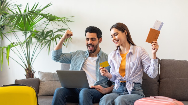 two people celebrating with laptop