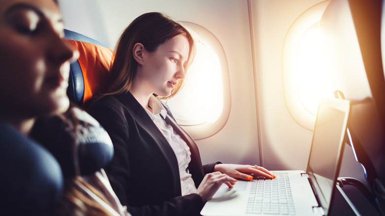 Woman in the window seat of an airplane