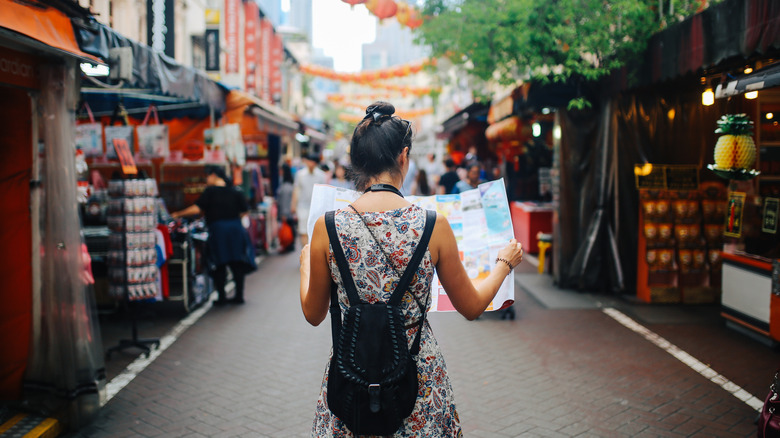 Woman walking alone with map