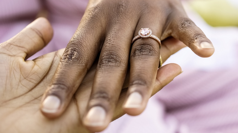 A pink ring on a finger