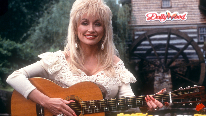 Dolly Parton posing with guitar