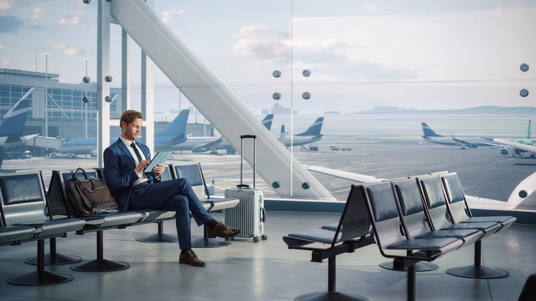 A man sitting at an airport gate