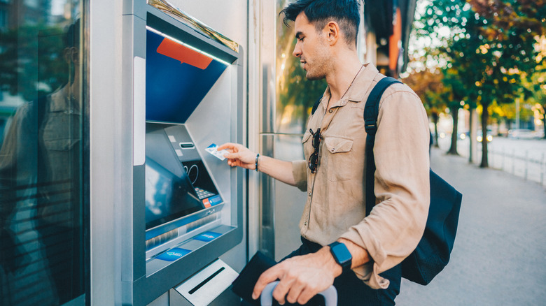 A traveler withdrawing money