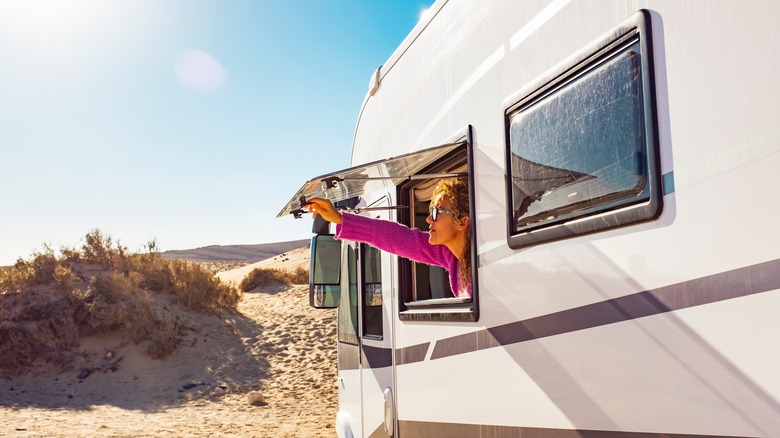 woman looking out rv window