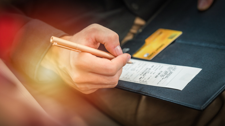 person signing a receipt