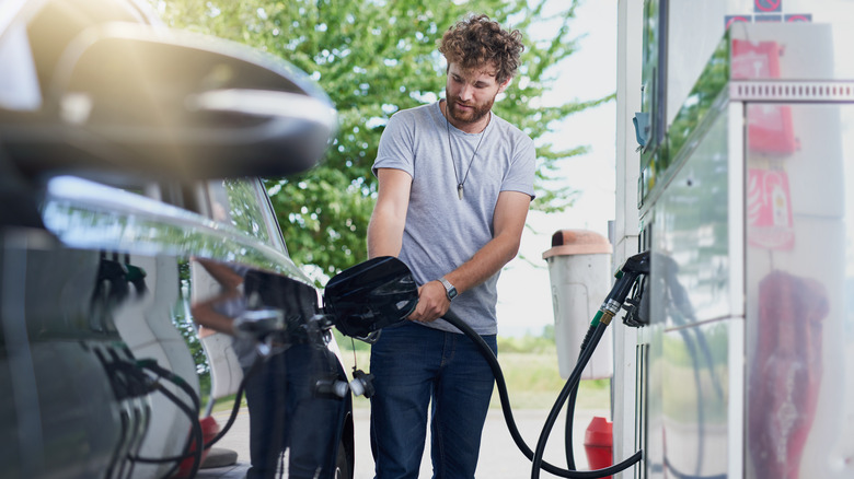 man filling up gas