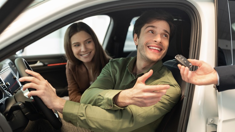 Couple receiving rental car key