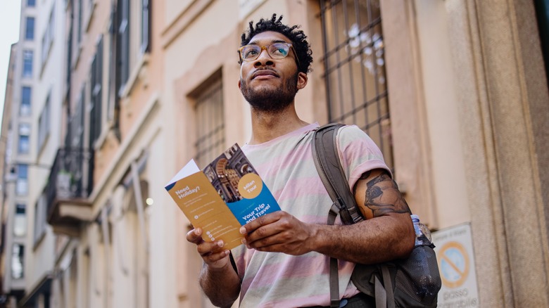 Man holding Milan tourist map