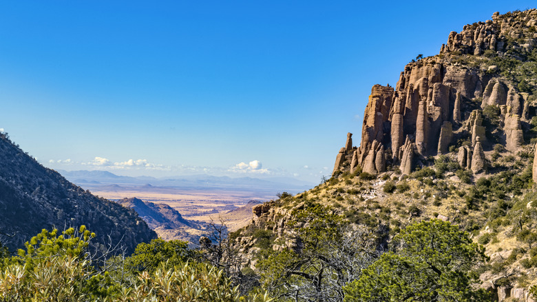 Hill with columns of rock formations leading to a valley