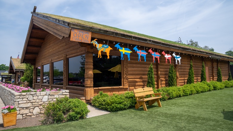 A log building with a sod roof and sheep signs in Sister Bay, Wisconsin