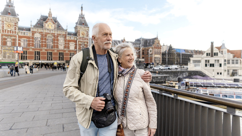 grey-haired couple walking in Amsterdam