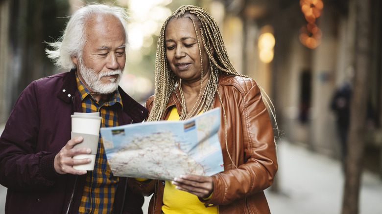 older couple reading map