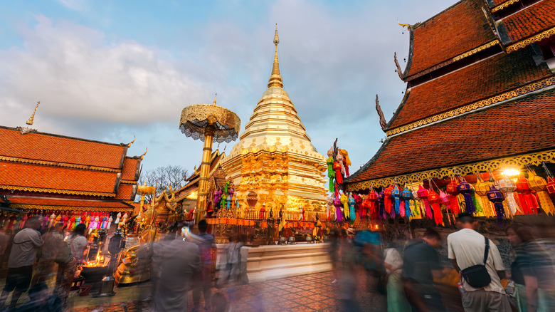 tourists at a market outside a temple in Chiang Mai, Thailand