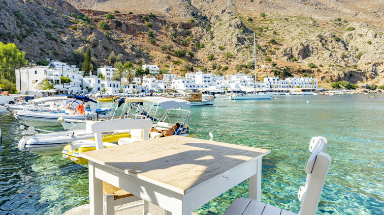 table at a restaurant overlooking an old port in Crete, Greece