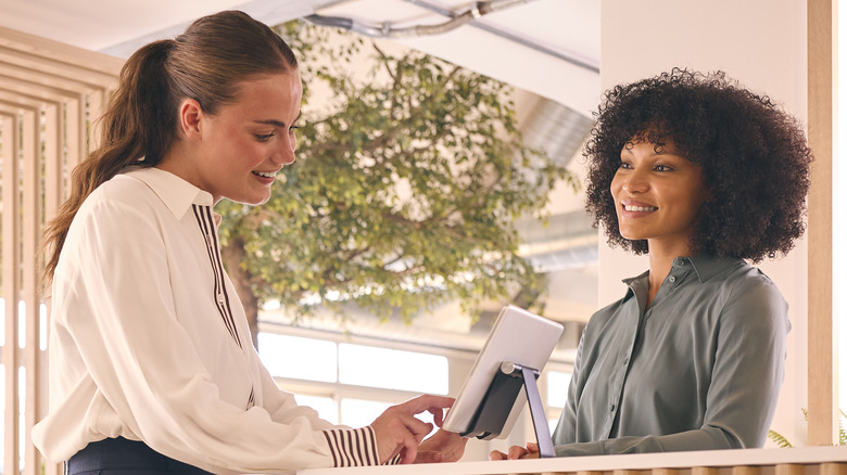 Woman checking in at hotel reception