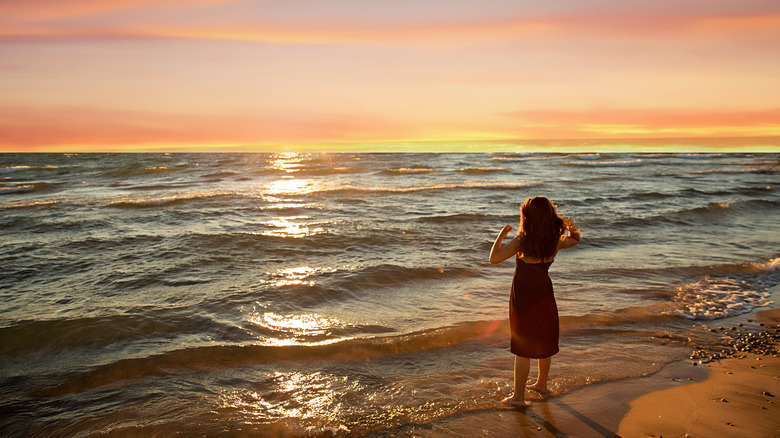 Woman standing on the shore at Wasaga Beach, Ontario, Canada