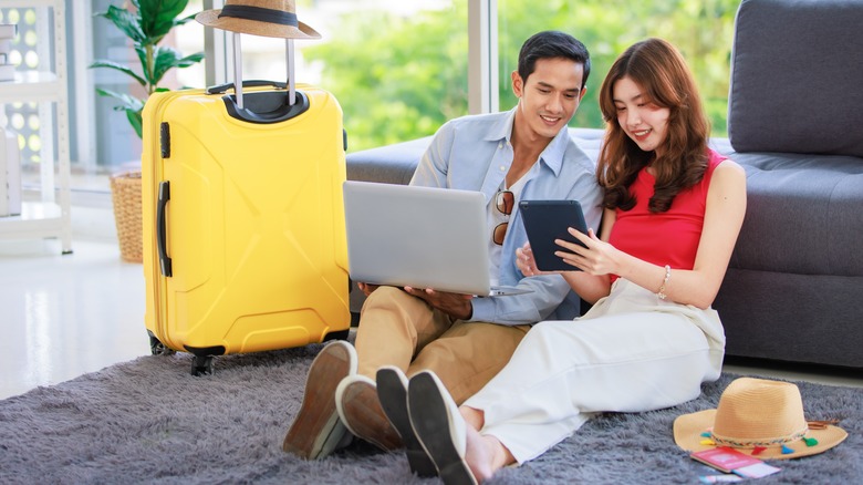 happy couple booking flights online