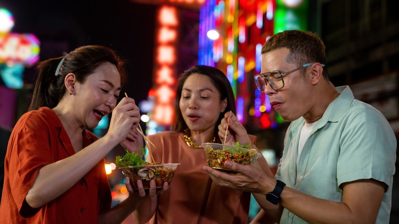 people eating street food night